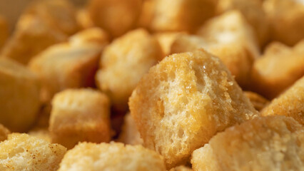 Macro shot of wheat croutons. Crunchy butter-flavoured croutons close-up.