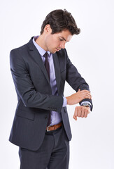 Naklejka premium Business, man and check time on watch in studio for schedule management, meeting reminder and late. Professional, person and reading clock for appointment delay, deadline update and white background