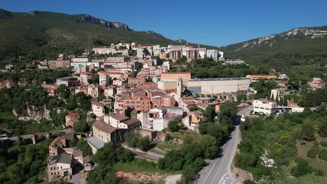 Forward reveal aerial shot of La Riba town on sunny summer day. Tarragona, Catalonia, Spain.