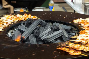 Fried shrimps on a huge grill close-up street food