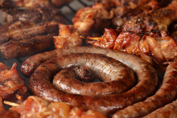 grilled sausage on the grill. South African braai meat including Boerewors, kebabs and chops 