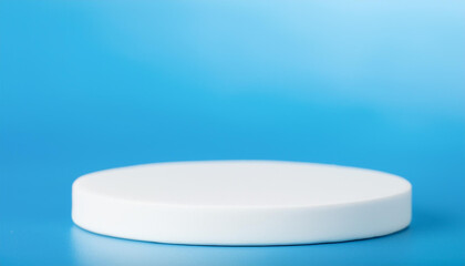 White ceramic podium. Scene for product presentation on blue backdrop.