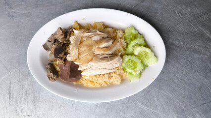 Chicken rice in a white plate on the dining table