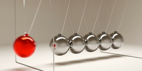 Newton's cradle with moving red ball over brown background, idea, impulse or start-up business concept