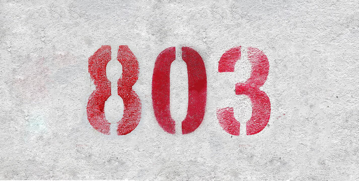 Red Number 803 on the white wall. Spray paint.