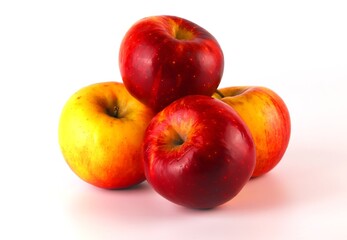 Red-yellow apples stacked on a white background. Ripe fruit ready to eat. Close-up shot.