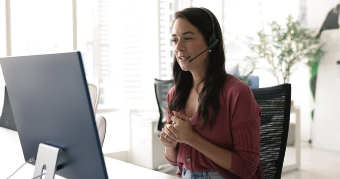 Young woman, helpline center employee provide assistance, resolve customer issues via videocall app or webchat on computer, helps with technical issues solving, effectively address customer inquiries