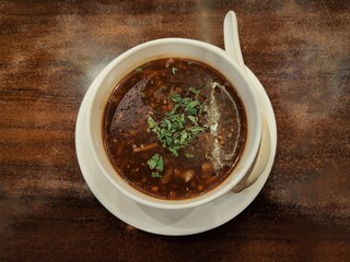 Manchow soup, indo chinese dish served over a wooden background