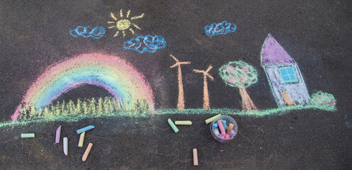 Obraz premium a child draws with chalk on the asphalt. beautiful picture.