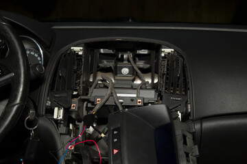 Installation of a modern multimedia system with a rear-view camera on the car. The installation center