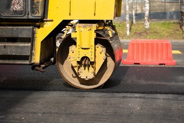 Laying of new asphalt on the city street.Road repairs. New asphalt.