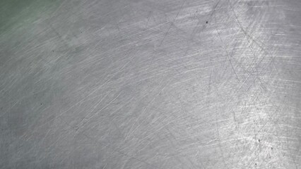 The steel plate surface has scratches from use.