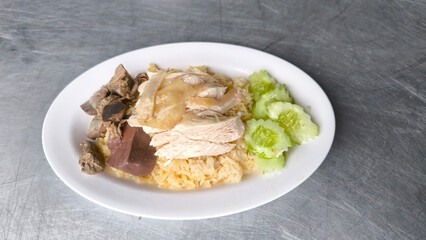 Chicken rice in a white plate on the dining table
