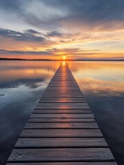 A wooden pier stretches out into a still lake, leading towards a vibrant sunset with the sun reflecting on the water's surface.
