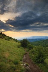 This image depicts a panoramic view of the hilly landscape from the path leading to Šiljak on mountain Rtanj