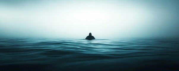 A solitary figure stands in a serene, foggy sea, surrounded by calm water and a tranquil atmosphere, evoking introspection and solitude.