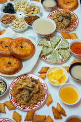 Meal with traditional Kyrgyz dishes served in the yurt. Local food in Kyrgyzstan.
