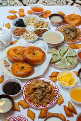 Meal with traditional Kyrgyz dishes served in the yurt. Local food in Kyrgyzstan.