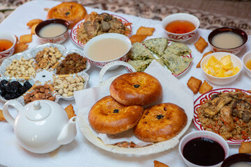 Meal with traditional Kyrgyz dishes served in the yurt. Local food in Kyrgyzstan.