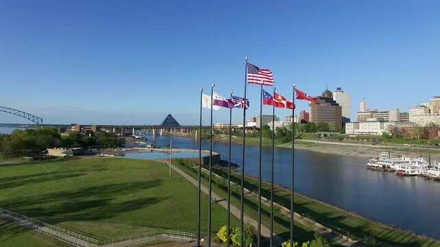 Waving Flags in Mud Island River Park, Memphis, Tennessee. Hernando de Soto Bridge and Mississippi River in Background. Drone