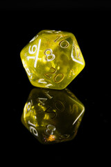 a translucent yellow twenty-sided dice with white numbers, showing the number eight, on a black background with a reflection