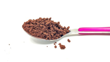 Photo of a spoonful of rich, aromatic instant coffee granules, ready to be brewed into a quick and...