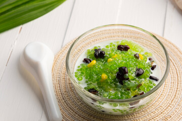 Pandan flavoured Black bean and corn Tapioca pearl pudding (Sago) with a dash of coconut milk,popular South-East Asian dessert in glass bowl