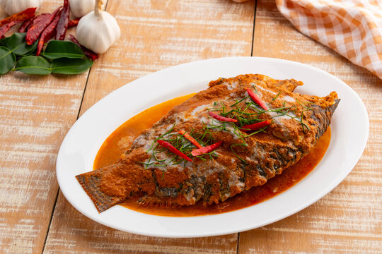 Tilapia Fish with red curry sauce,Thai Chu Chee Fish Curry in a plate.