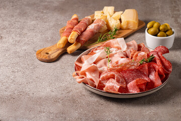 Charcuterie board. Antipasti appetizers of meat platter with salami, prosciutto crudo or jamon and olives.