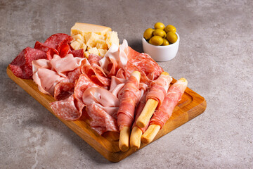 Charcuterie board. Antipasti appetizers of meat platter with salami, prosciutto crudo or jamon and olives.