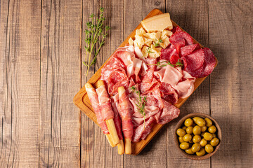 Charcuterie board. Antipasti appetizers of meat platter with salami, prosciutto crudo or jamon and olives.