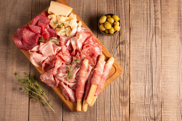 Charcuterie board. Antipasti appetizers of meat platter with salami, prosciutto crudo or jamon and olives.