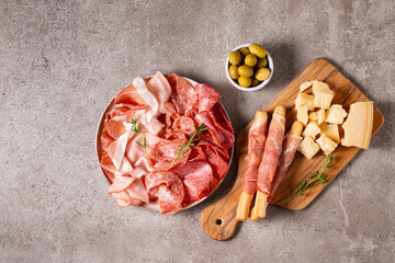 Charcuterie board. Antipasti appetizers of meat platter with salami, prosciutto crudo or jamon and olives.