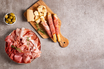 Charcuterie board. Antipasti appetizers of meat platter with salami, prosciutto crudo or jamon and olives.