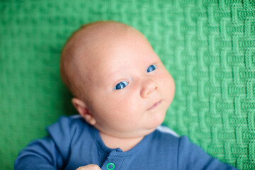 Little baby on colorful knitted blanket