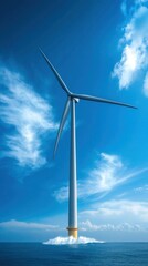 Fototapeta premium A stunning offshore wind turbine standing tall against a vibrant blue sky and ocean, symbolizing renewable energy and sustainability.