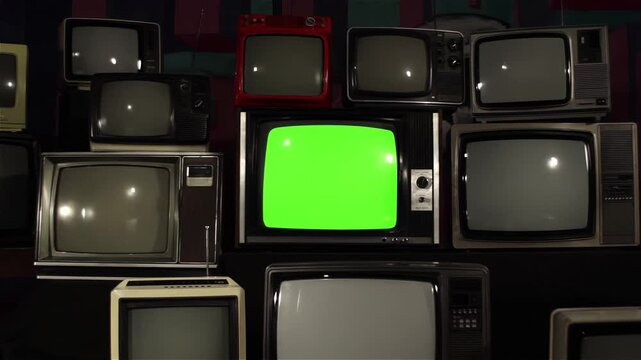 Dolly In on Green Screen Old TV Amongst Many Vintage 80s and 90s TVs - You Can Replace Green Screen with the Footage or Picture You Want with 'Keying' Effect (Check Out Tutorials)  - 4K