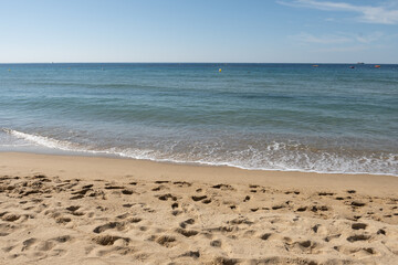 Morning view on crystal clear blue water of Plage du Debarquement white sandy beach near Cavalaire-sur-Mer and La Croix-Valmer, summer vacation on French Riviera, Var, France