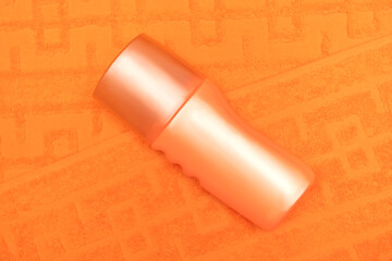 Orange cosmetic cream on an orange towel. Body and face care.