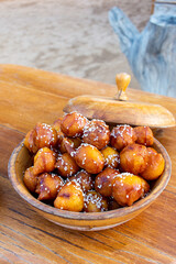 Luqaimat in a wooden plate in Dubai. The iconic Emirati traditional dessert.