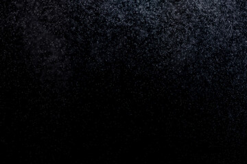 small drops of rain, snow on a black background. wind. Natural background