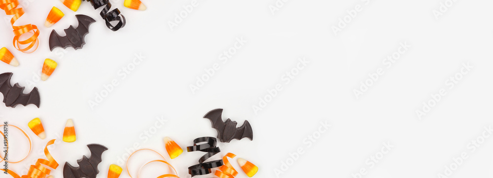 Poster halloween corner border of black, white and orange color candy and ribbon. above view on a white ban