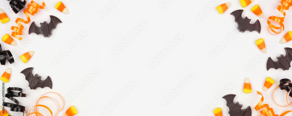 Poster halloween double border of black, white and orange color candy and ribbon. top down view on a white 