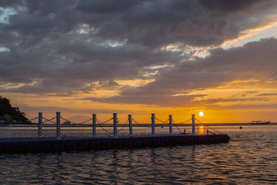 PG Island, Oriental Mindoro Province, Philippines - Silhouette of people on the beach at sunset