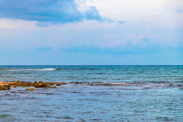 Tropical Caribbean beach people parasols fun Playa del Carmen Mexico.