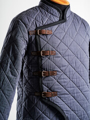 Historical fashion. Medieval knight cloth. Padded jacket gambeson.