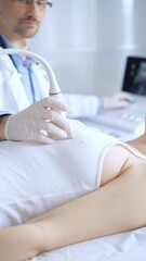 Obraz premium Doctor man wearing white protective gloves is using ultrasound equipment on the breast of a female patient. Mammary gland health. Medicine concept