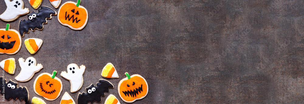 Poster halloween cookie corner border. above view on a dark stone banner background with copy space. ghosts