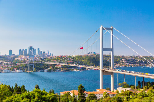 Istanbul Bosphorus Bridge or 15th July Martyrs Bridge with Istanbul panorama cityscape during summer sunny day. Istanbul, Turkiye.