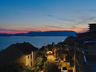 View on Croatian Adriatic sea coastline and a village during sunset 
